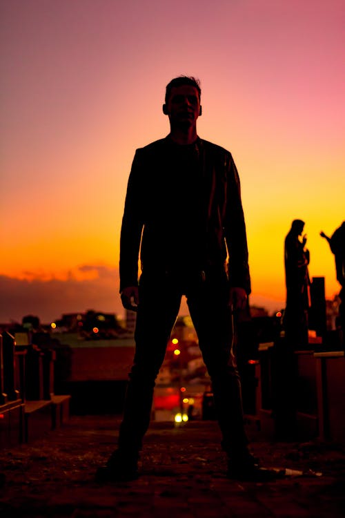 Standing Man Wearing Jacket and Pants during Sunset