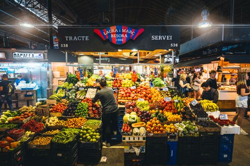 Free Colorful market stall displaying fresh fruits and vegetables in Barcelona's bustling market. Stock Photo