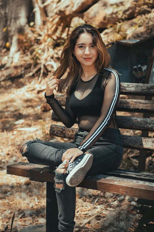 A woman sitting on a bench in the woods