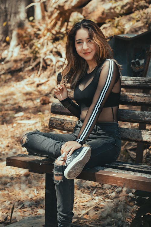 A woman sitting on a bench in the woods