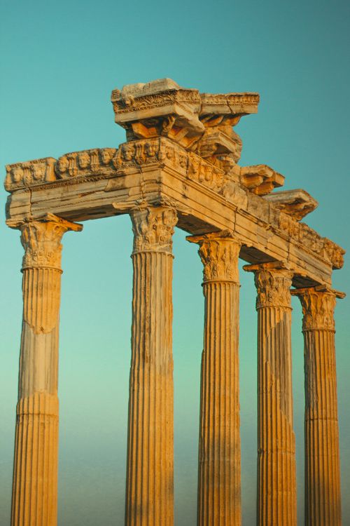 Free Majestic Corinthian columns from a historic temple in Side, Turkey, at sunset. Stock Photo