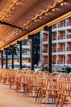 Warmly lit café terrace with empty chairs in Alanya, Antalya, Türkiye.