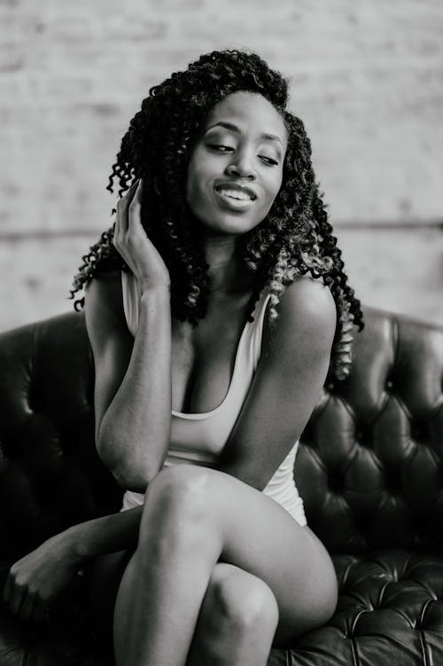 Smiling Woman Sitting in Black and White