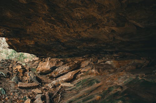 A man is standing in the middle of a cave