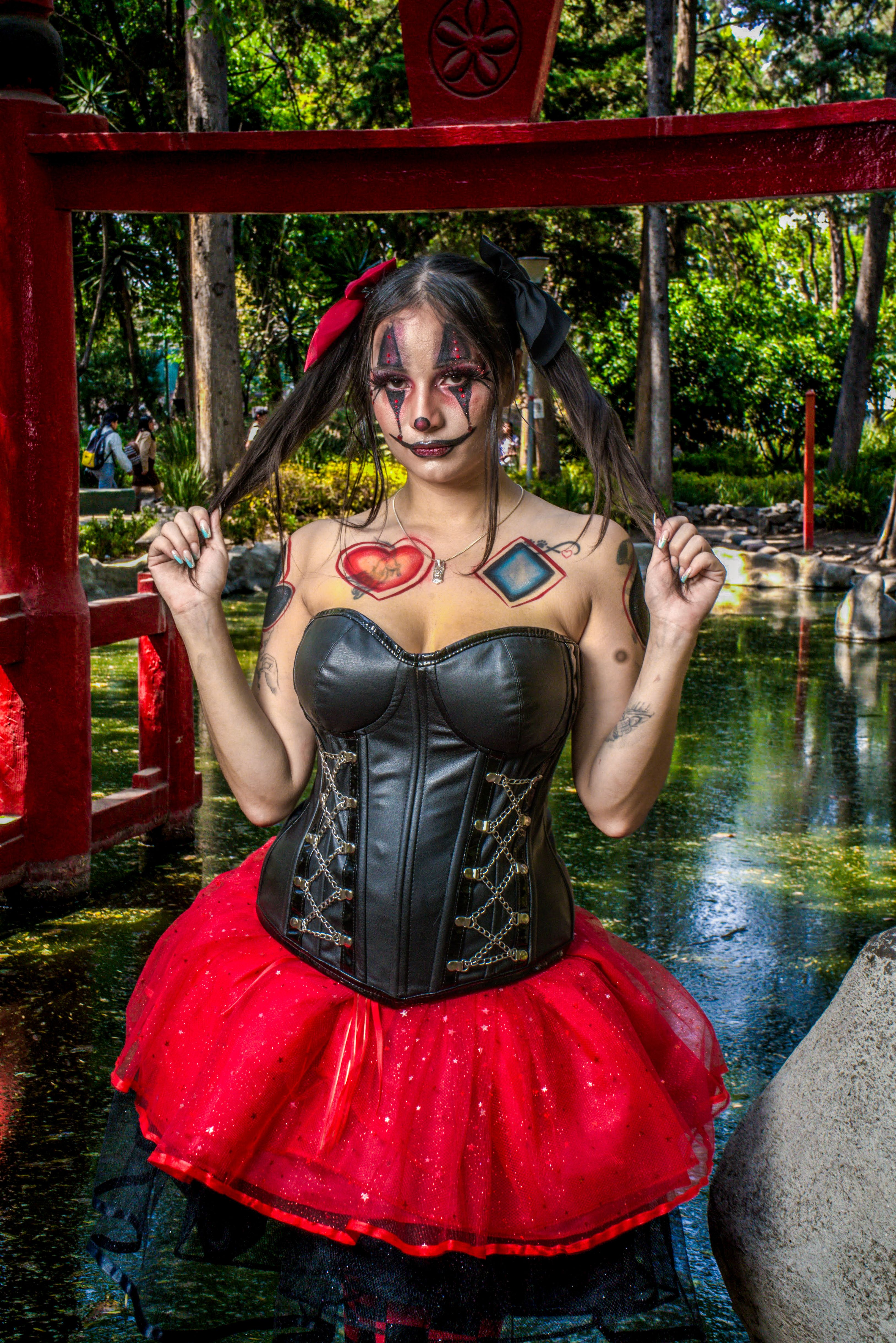 A woman dressed in a red and black costume · Free Stock Photo