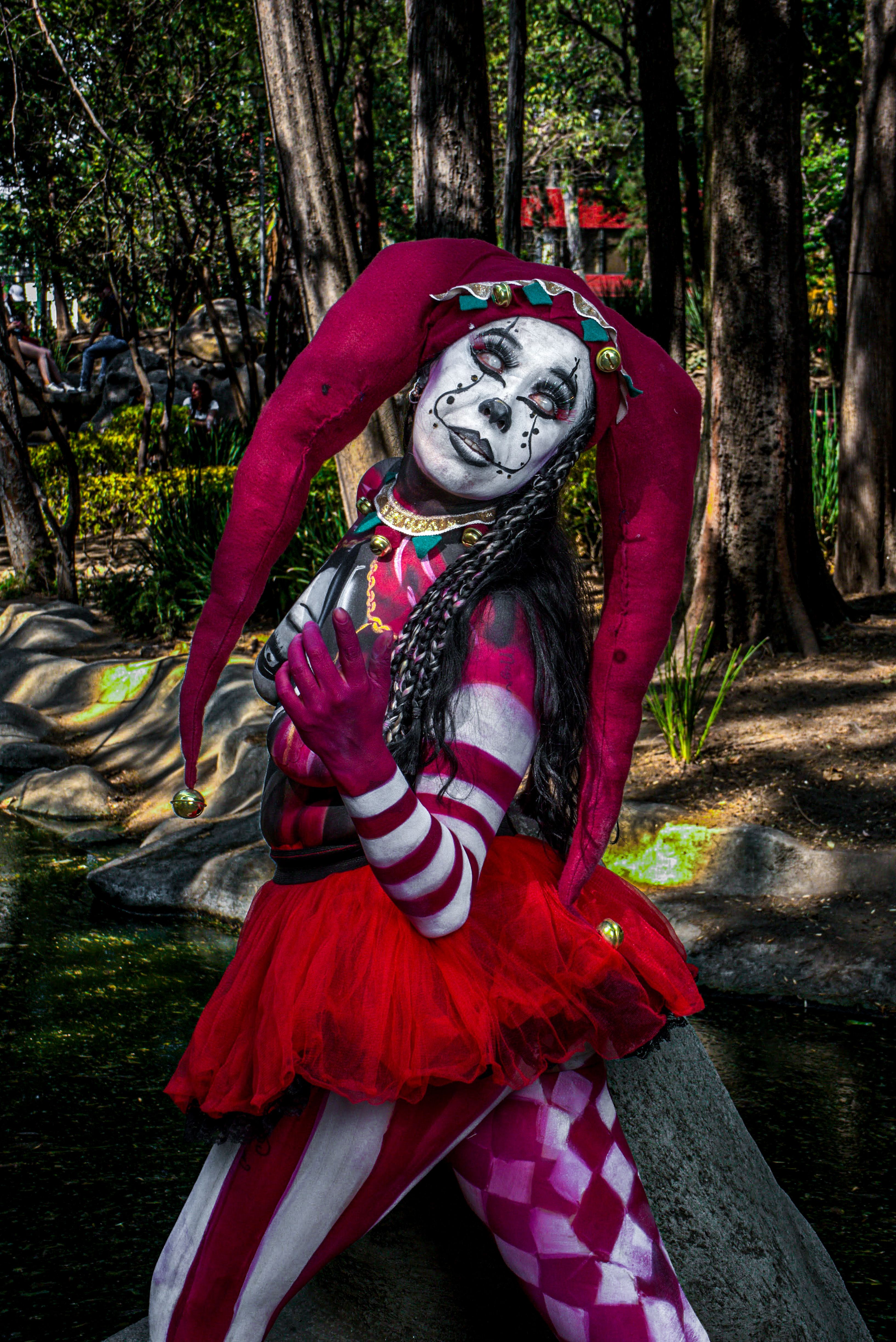 A woman dressed as a clown with red and white makeup · Free Stock Photo