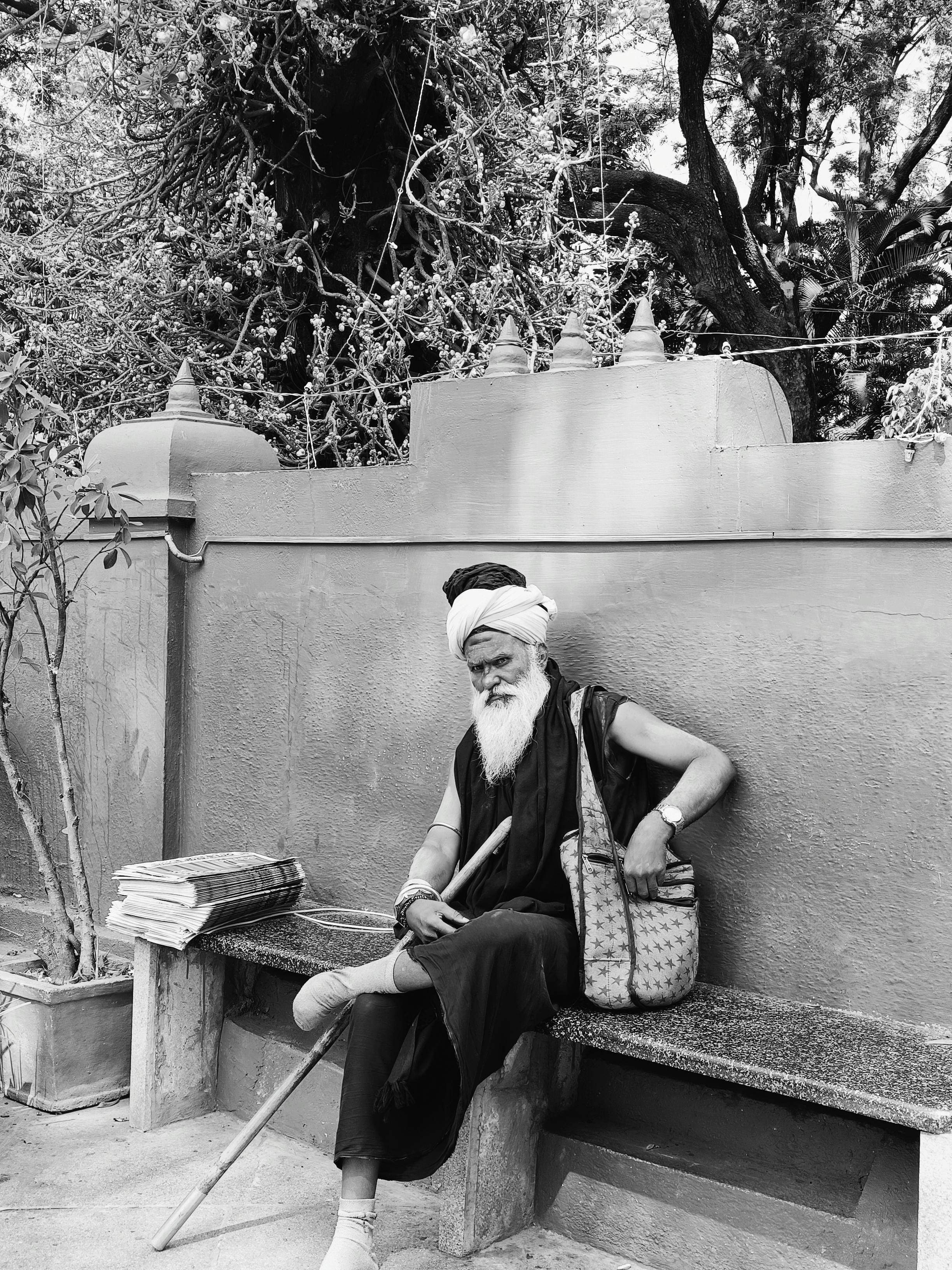 man with beard sitting on bench