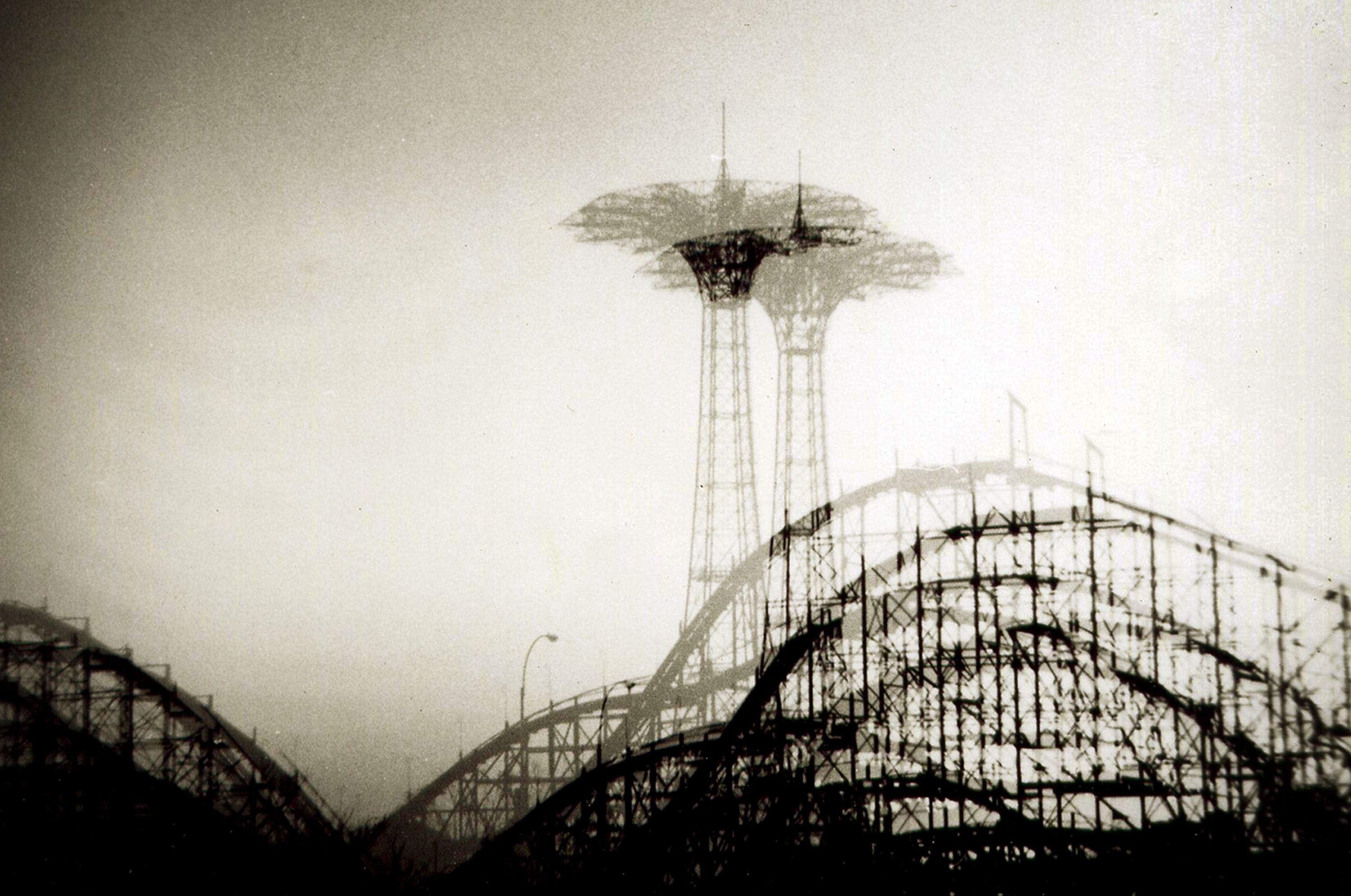 Atmospheric black and white shot of Coney Island's iconic amusement park structures.