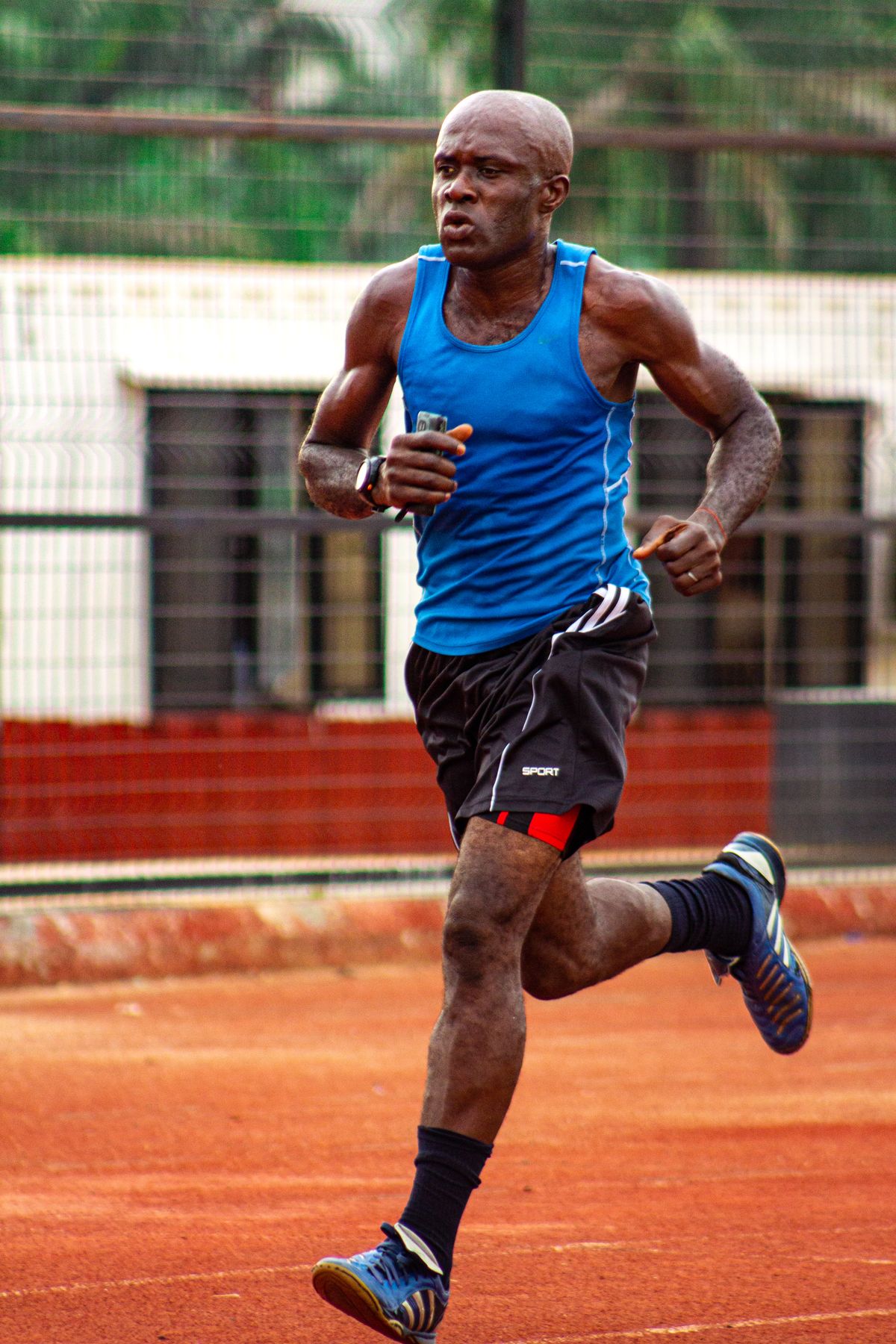 Runner in performance sportswear training on an outdoor track
