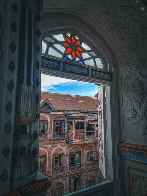 A view of a window in a building with a red roof