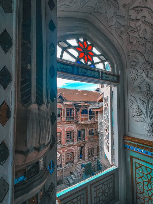 A view of a window in a building with a view of the city