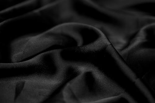 Black satin fabric with a dark background