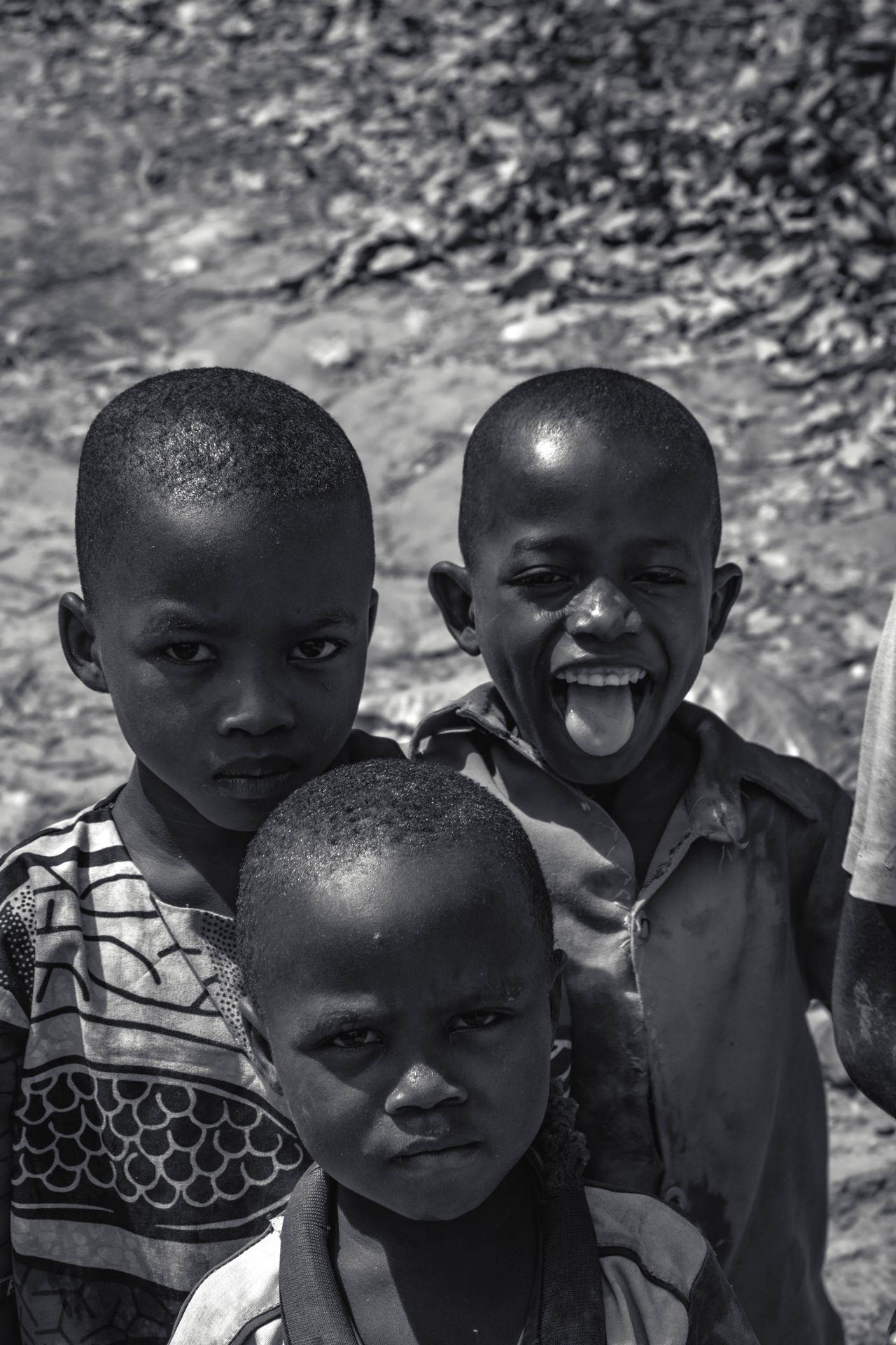 Burundian boys walking together on a road at sunrise
