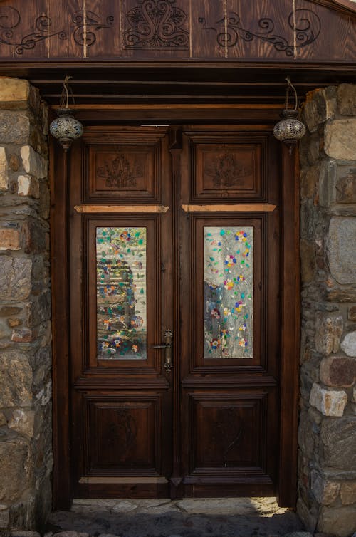A wooden door with glass panels on the front