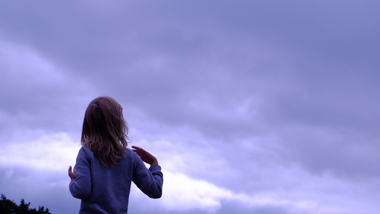 Free Woman in Blue Sweater Facing in Blue Clear Sky Stock Photo