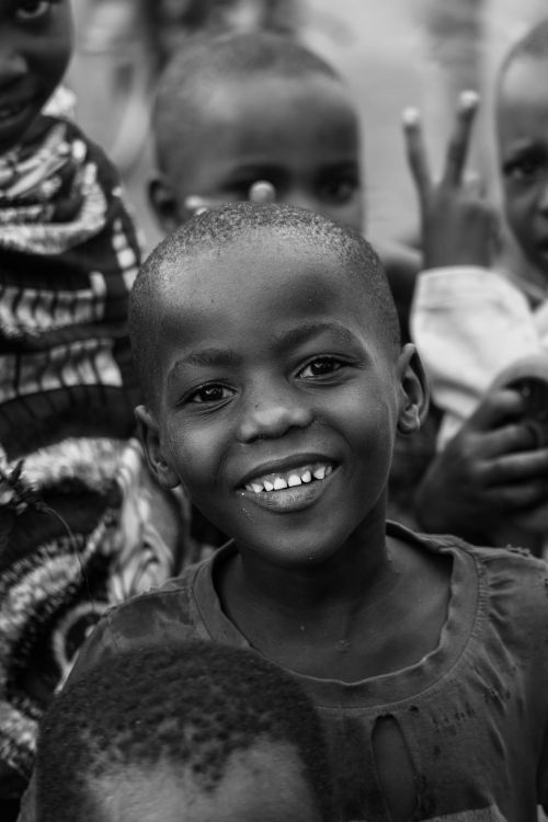 Free Black and white photo capturing joyful children smiling in Bujumbura, Burundi. Stock Photo