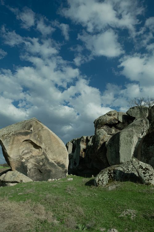 Free Stunning view of eroded rock formations beneath a wide blue sky with scattered clouds. Stock Photo
