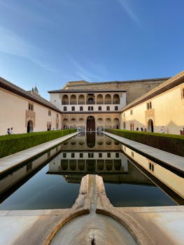 Stunning view of the Alhambra courtyard reflecting pool in Granada, Spain.