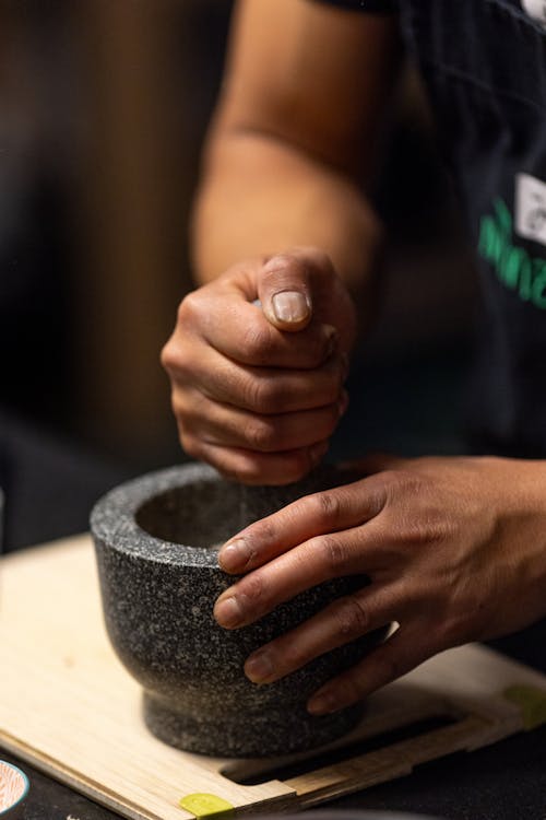 A person is holding a mortar and pestle
