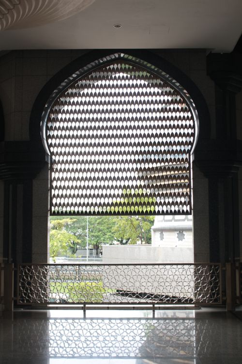 Ornate Islamic latticework inside a mosque in Brunei