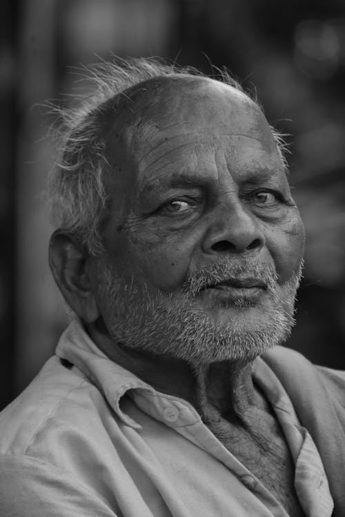 An old man with a beard and a black and white photo