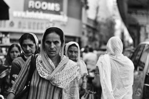 A black and white photo of women walking down the street
