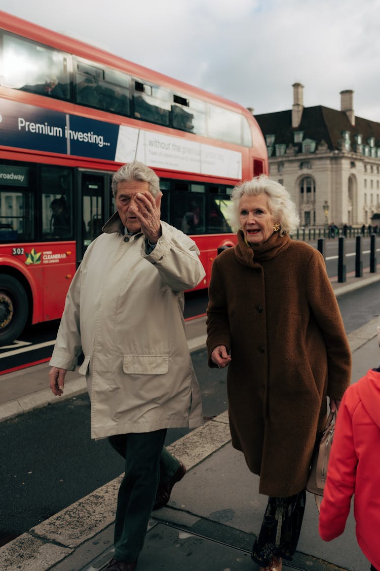 Man And Woman Walking On Sidewalk 