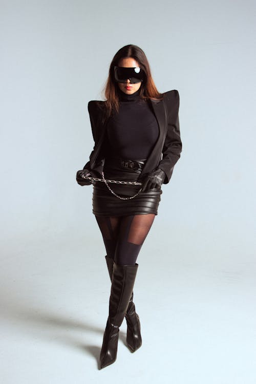 Woman in Black Mini Skirt, Over Knees Boots and Shades