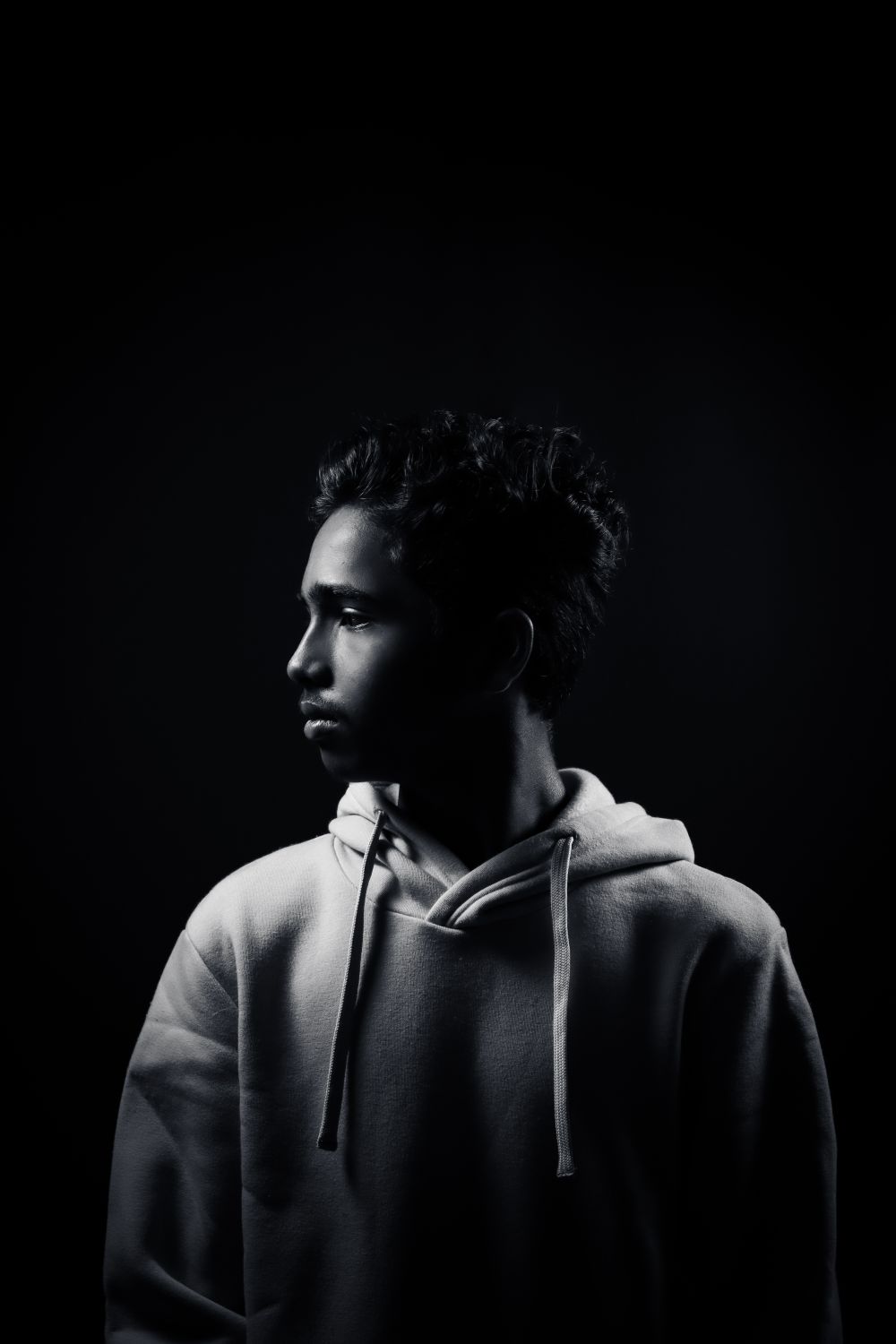 Studio portrait against black — photo by PXLFLASH on Pexels