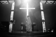 Priest Standing On A Podium During Mass