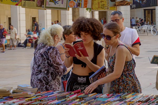 free photo of women and man standing in front of market