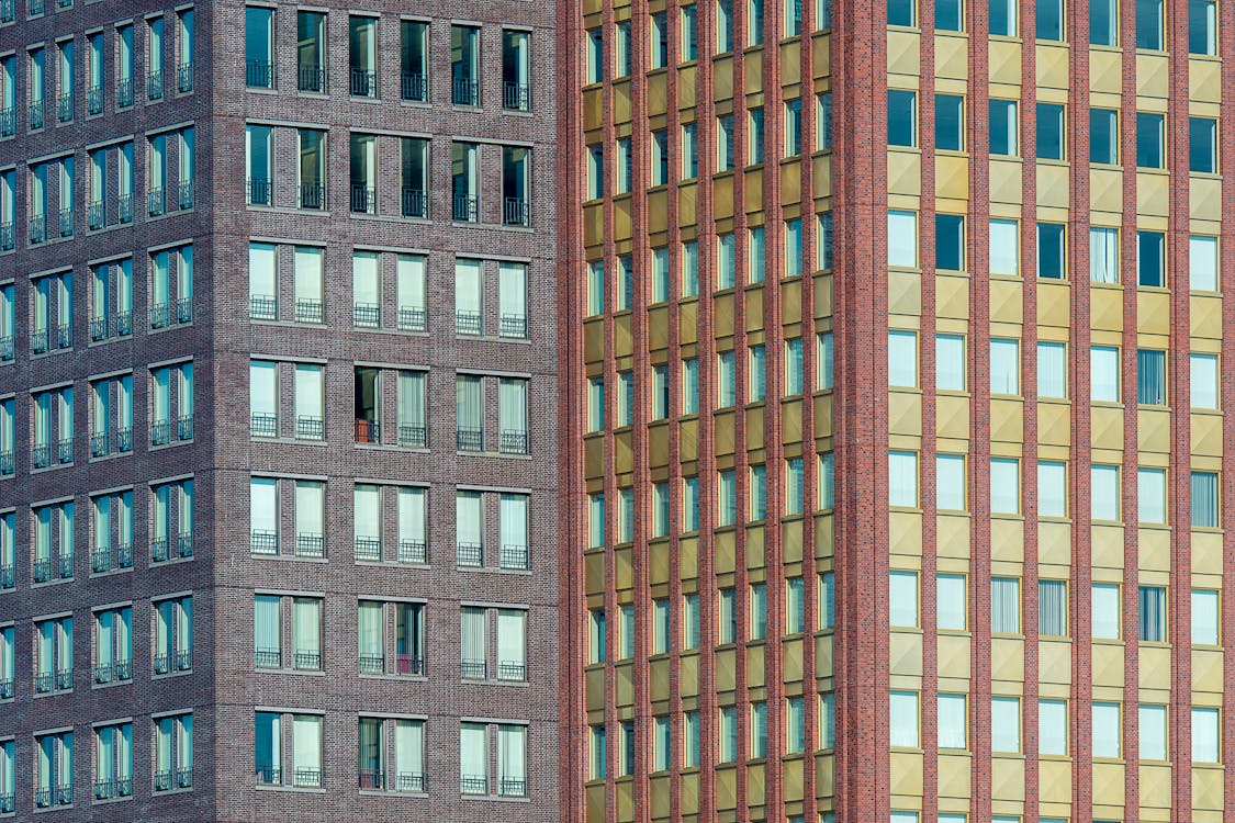 A building with windows and a red and blue sky