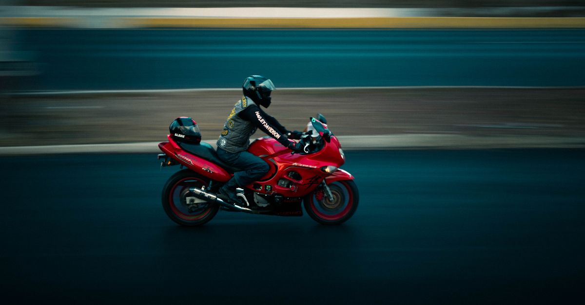 Man Riding Red Suzuki Motorbike · Free Stock Photo