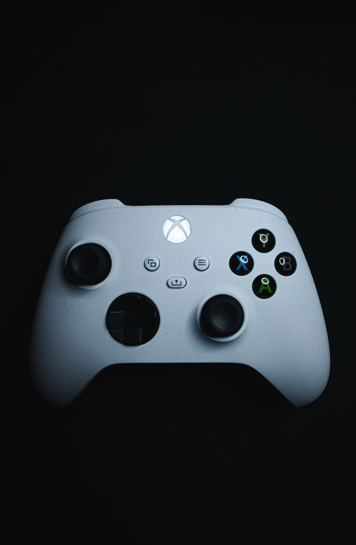 Black Gaming Controller on Dark Background · Free Stock Photo