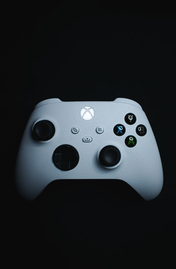 Black Gaming Controller on Dark Background · Free Stock Photo