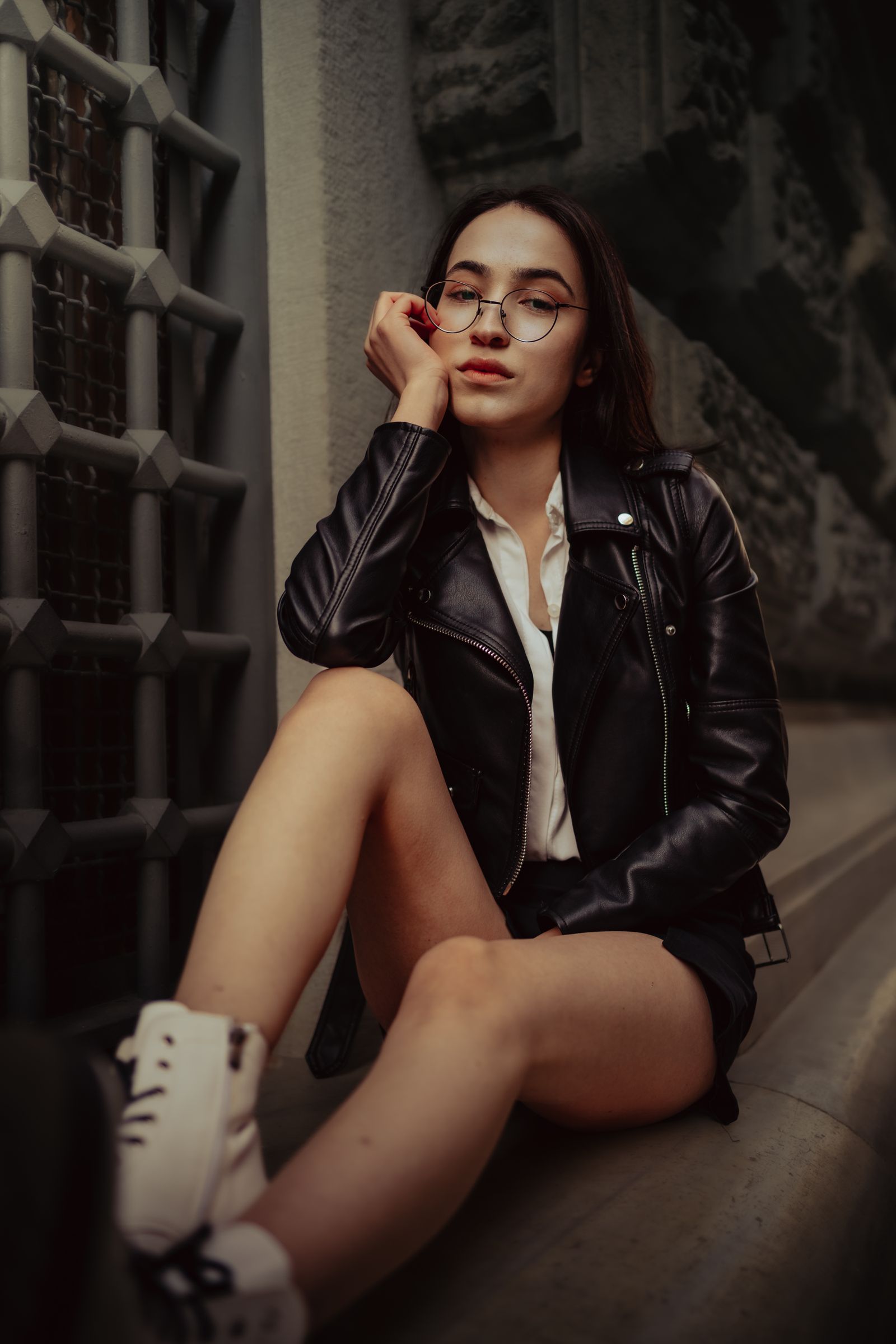Woman in Black Leather Jacket and Blue Denim Jeans Sitting on Floor ...