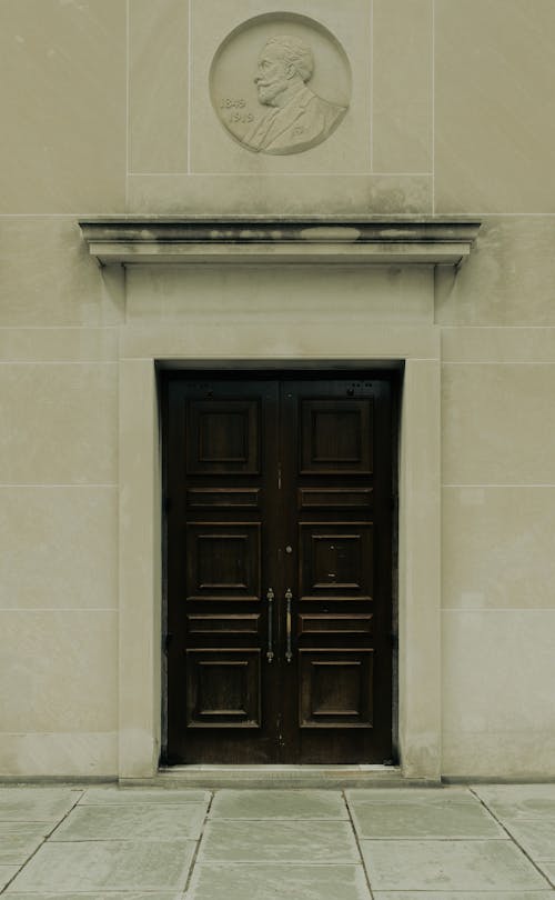 The front door of a building with a statue on it