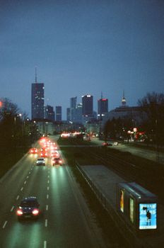 Beautiful evening view of Warsaw's skyline with cars on the road