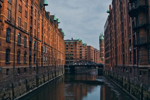 Free Explore the iconic brick buildings and serene canal of Hamburg's Speicherstadt, a UNESCO heritage site. Stock Photo