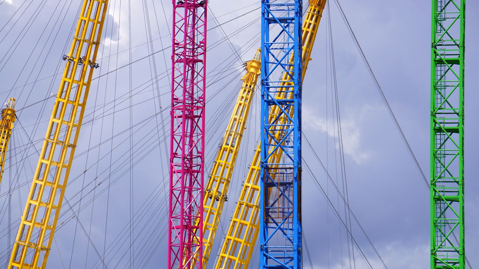 Blue Yellow Red and Green Metal Bar With Metal Sprint in Low Angle Photography