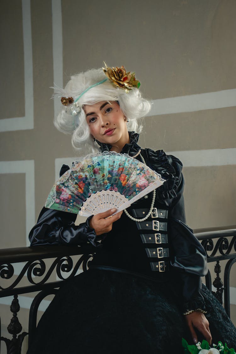 Woman Posing In A Costume With A Hand Fan