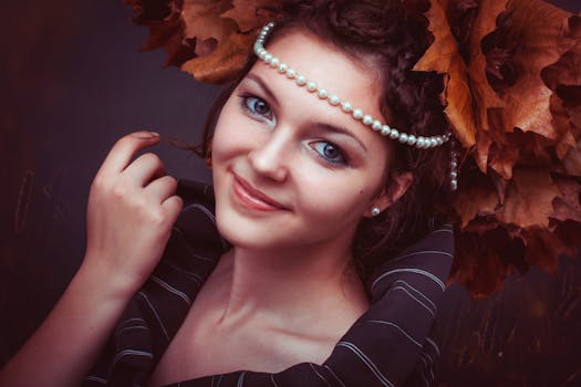 Beautiful woman with pearl jewelry and autumn foliage, exuding elegance.