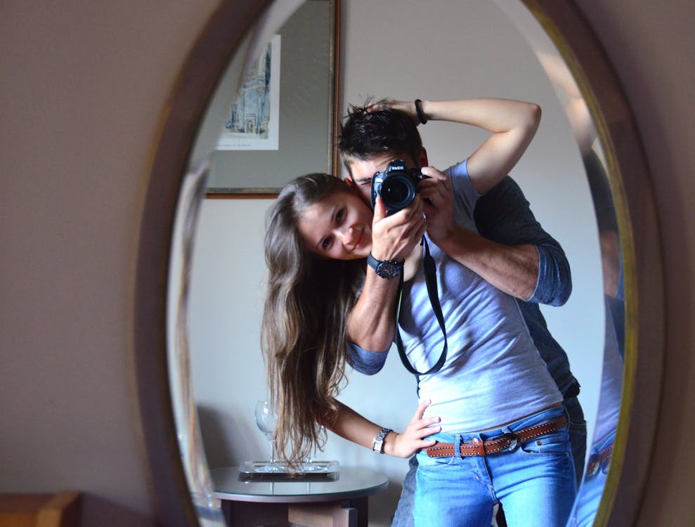 Free Man and Woman Taking Photo in Front of Mirror Stock Photo