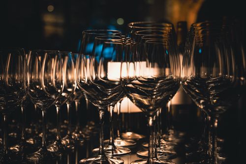 Free A sophisticated array of wine glasses on a dimly lit bar in Tokyo, Japan. Stock Photo