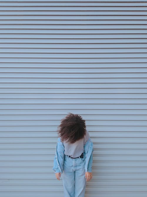 Woman Standing by Closed Shutter Door