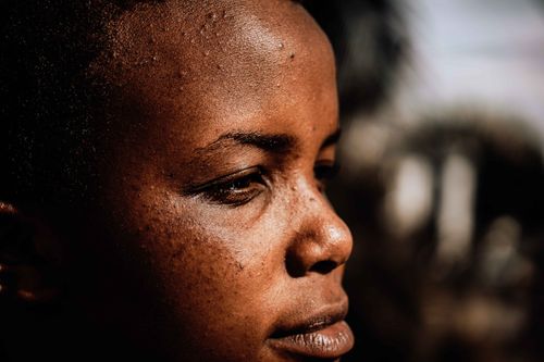 Free Close-up of a pensive woman in side profile, showcasing texture and contemplative mood. Stock Photo