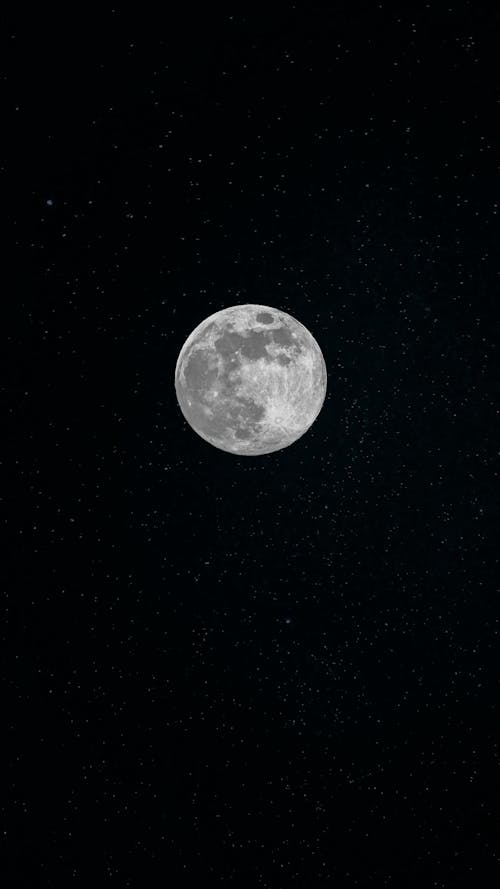 A full moon is shown in the dark sky