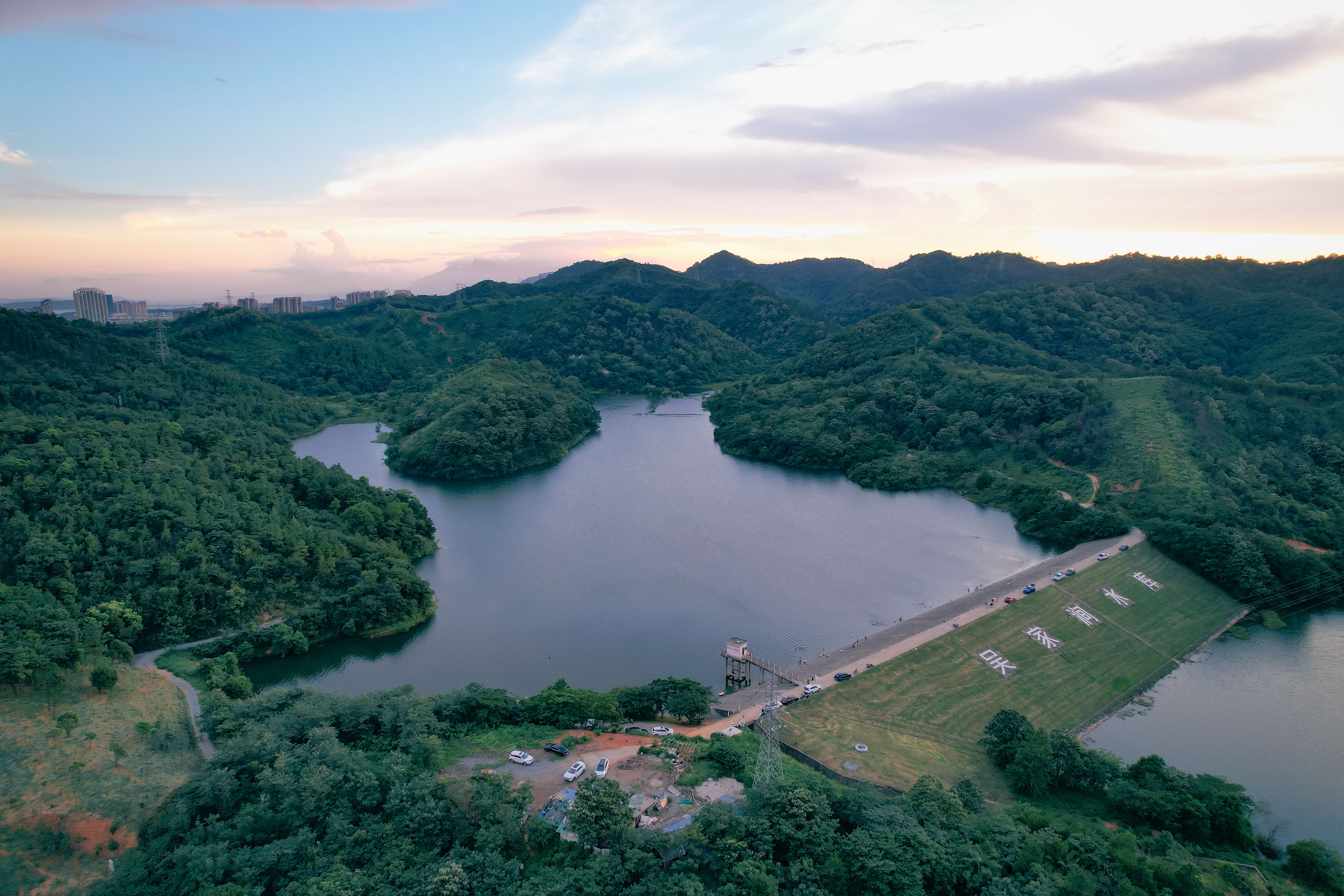 Aerial View of a Lake and Green Hills · Free Stock Photo
