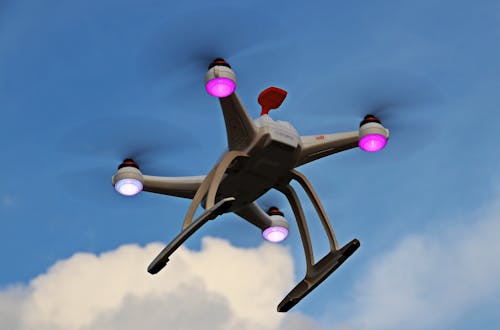 Free Turned-on White Quadcopter in the Sky Stock Photo