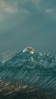 Scenic snowcapped mountains under cloudy skies in Sarsing, Iraq.